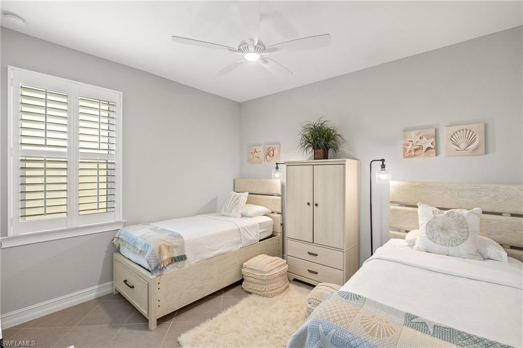 14671 Topsail Drive Naples, FL 34114 - Photo 20 of 36 a bedroom with a bed and a chandelier