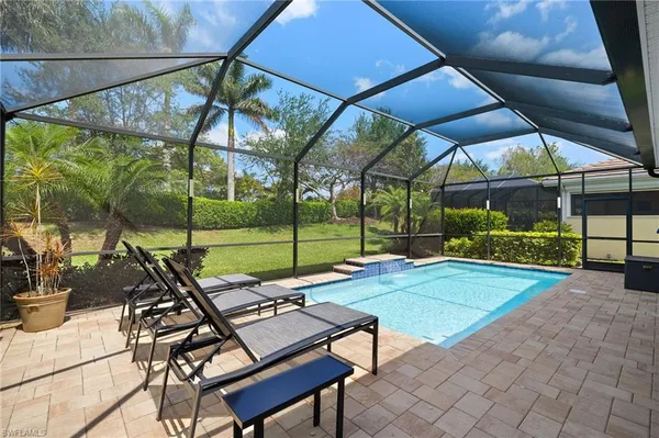 a view of a backyard with sitting area