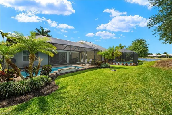 a view of a house with backyard and sitting area