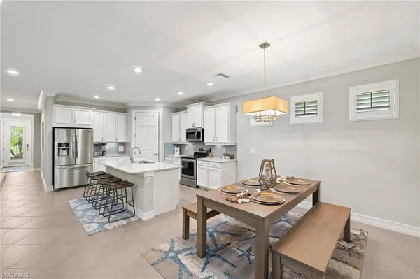 a kitchen with a table and chairs in it