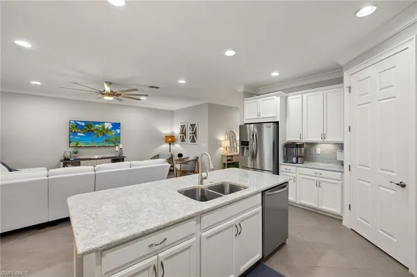 a kitchen with sink cabinets and refrigerator