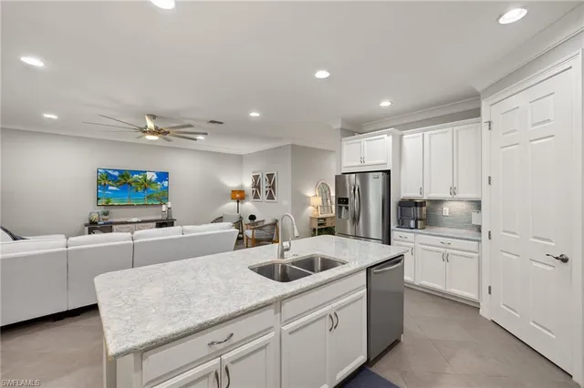 a kitchen with sink cabinets and refrigerator