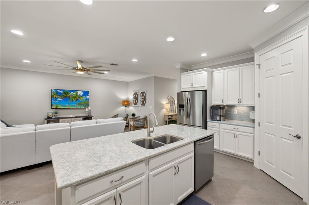 14671 Topsail Drive Naples, FL 34114 - Photo 8 of 36 a kitchen with sink cabinets and refrigerator