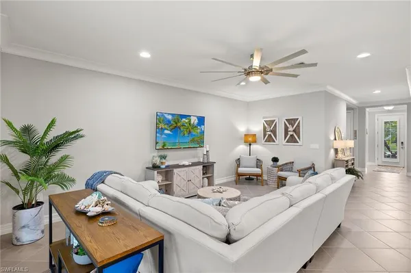 a living room with furniture and a potted plant