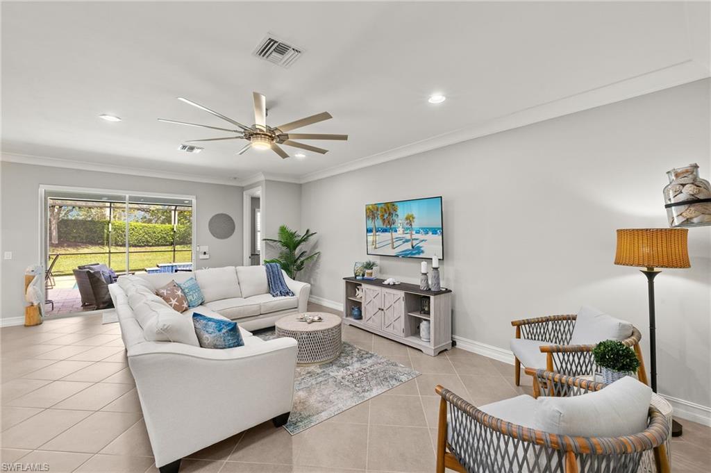 14671 Topsail Drive Naples, FL 34114 - Photo 10 of 36 a living room with furniture and a large window