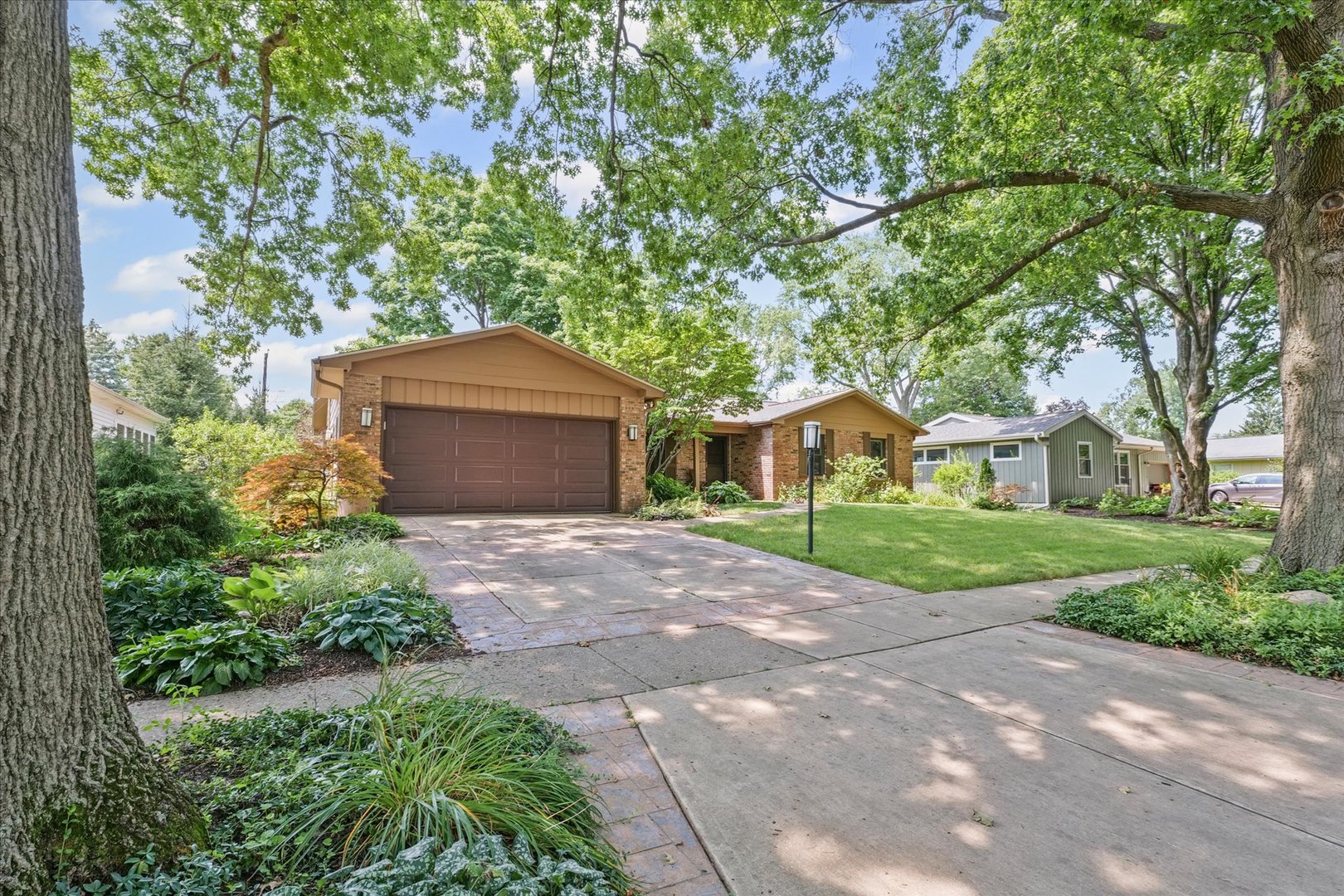 2119 Galen Drive Champaign, IL 61821 - Photo 3 of 39 a front view of a house with a garden and trees
