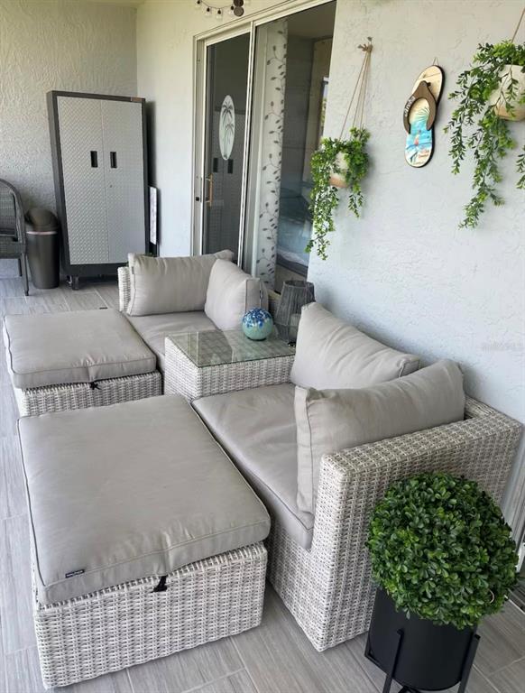 5537 Sea Forest Drive, Unit 208 New Port Richey, FL 34652 - Photo 12 of 26 a living room with furniture and a potted plant