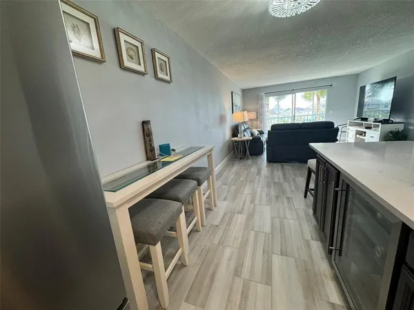a view of a livingroom with furniture wooden floor and windows