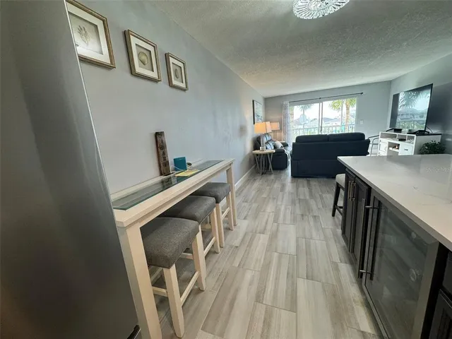 a view of a livingroom with furniture wooden floor and windows