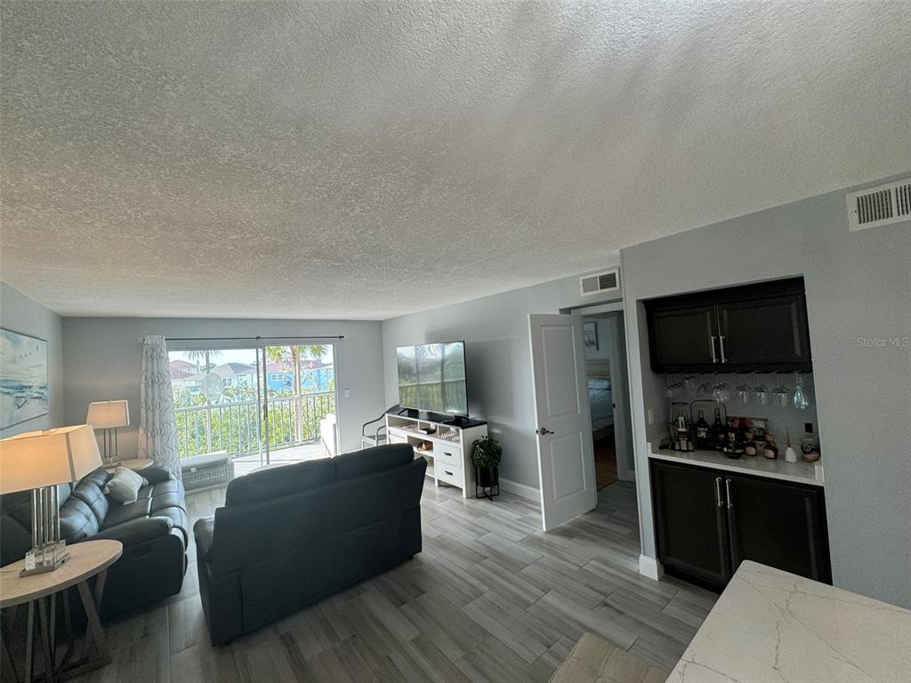 5537 Sea Forest Drive, Unit 208 New Port Richey, FL 34652 - Photo 15 of 26 a living room with furniture and a flat screen tv