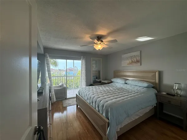 a bedroom with a large bed and a chandelier