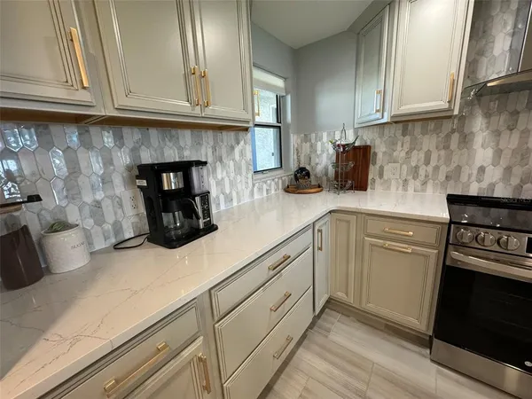 a kitchen with sink and cabinets