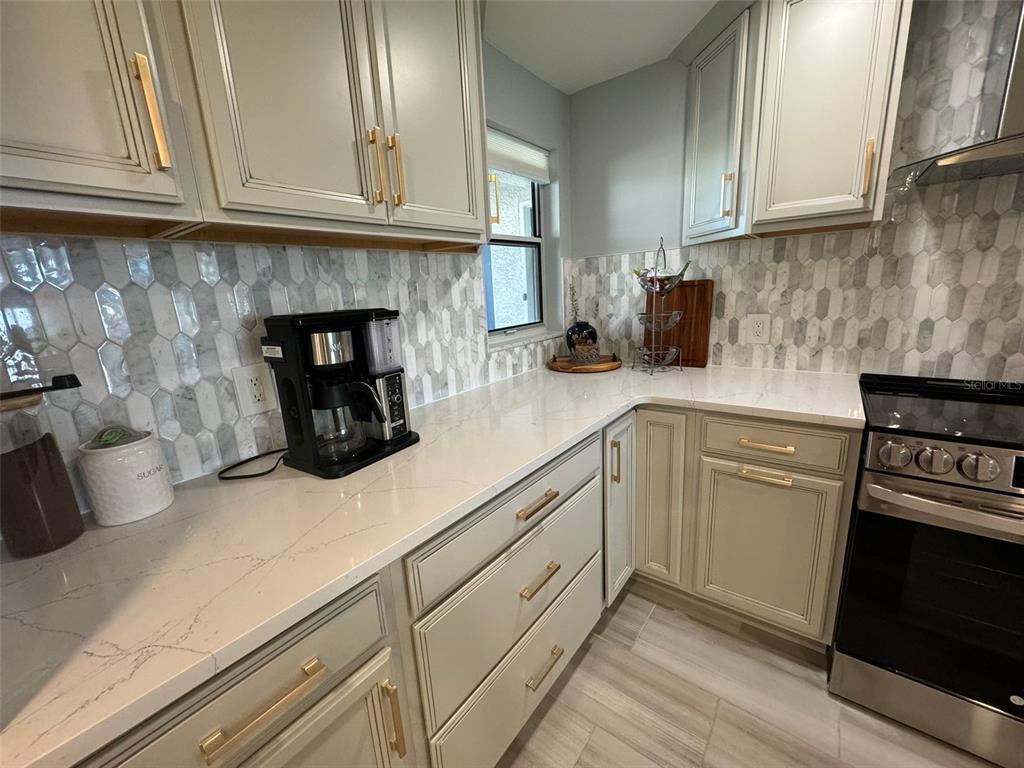 5537 Sea Forest Drive, Unit 208 New Port Richey, FL 34652 - Photo 5 of 26 a kitchen with sink and cabinets