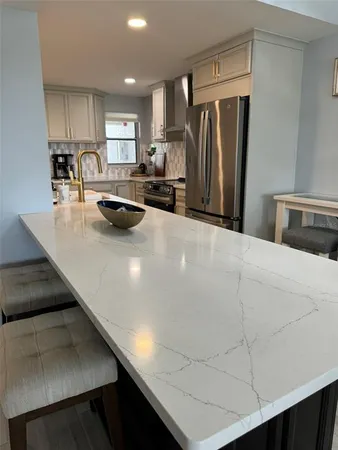 a kitchen with stainless steel appliances a refrigerator and a sink
