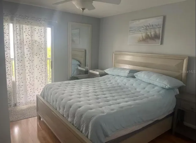 a large bed sitting in a bedroom next to a window