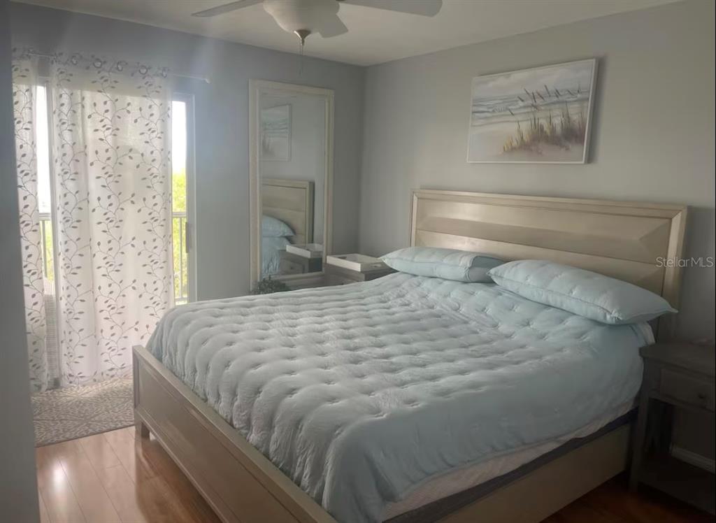 5537 Sea Forest Drive, Unit 208 New Port Richey, FL 34652 - Photo 9 of 26 a large bed sitting in a bedroom next to a window