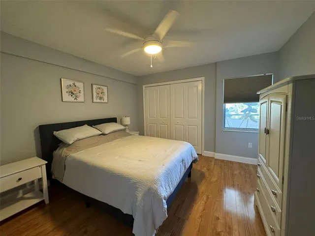 a bedroom with a bed and a painting on the wall