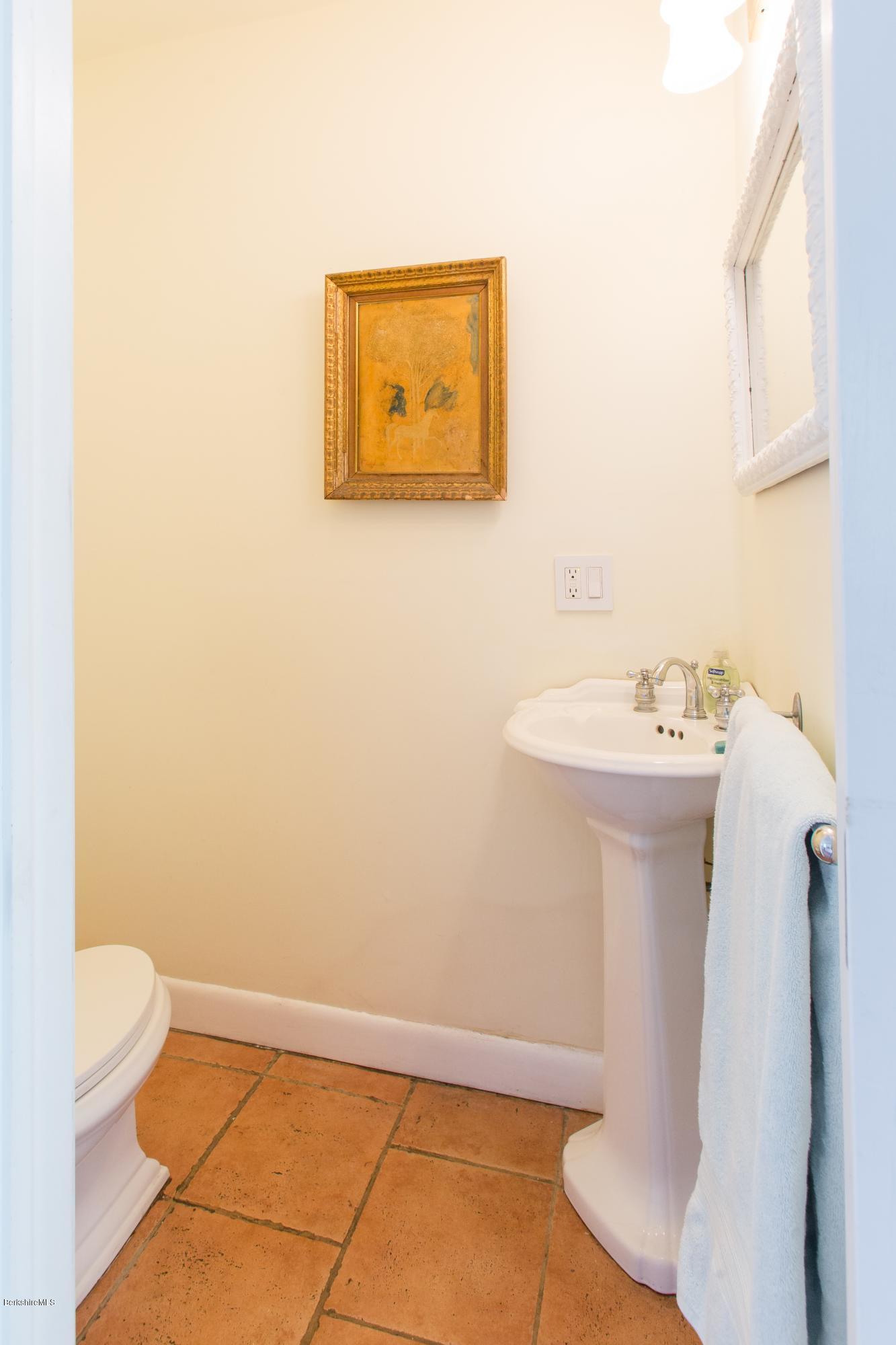 49 New Hartford Road Sandisfield, MA 01255 - Photo 23 of 41 a bathroom with a sink a toilet and a mirror