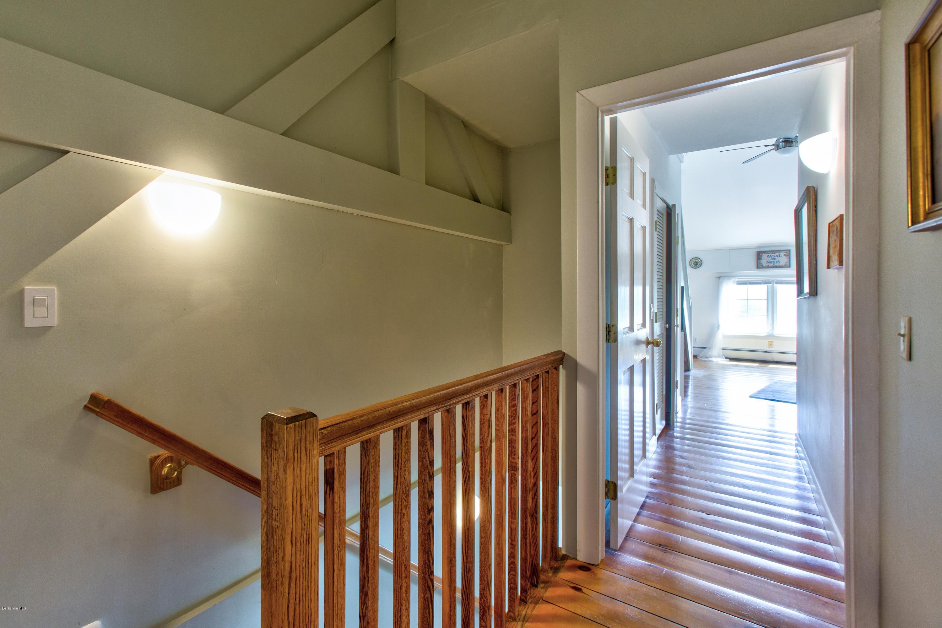 49 New Hartford Road Sandisfield, MA 01255 - Photo 30 of 41 a view of a hallway with wooden floor and staircase