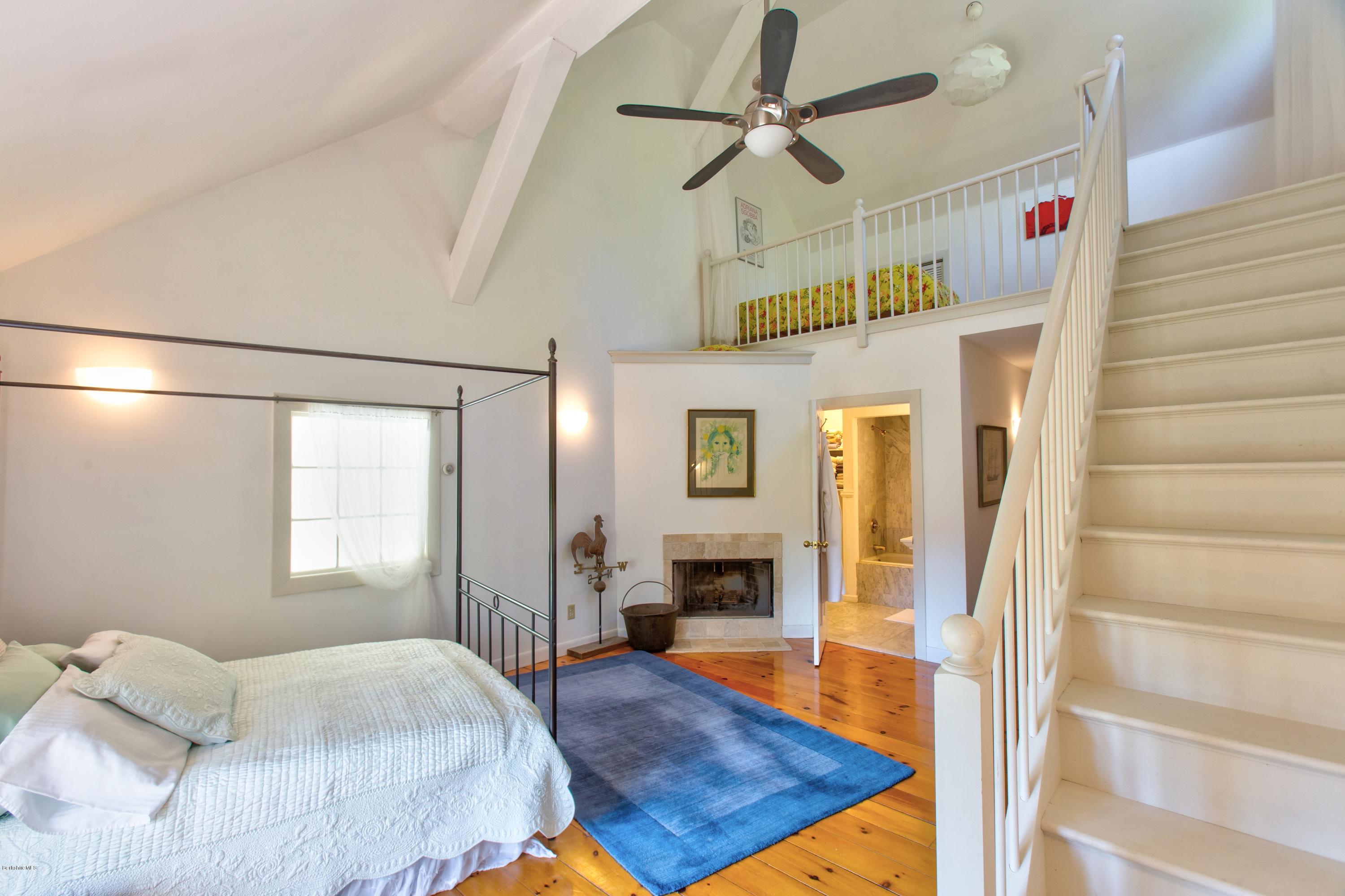 49 New Hartford Road Sandisfield, MA 01255 - Photo 31 of 41 a bedroom with a bed and wooden floor