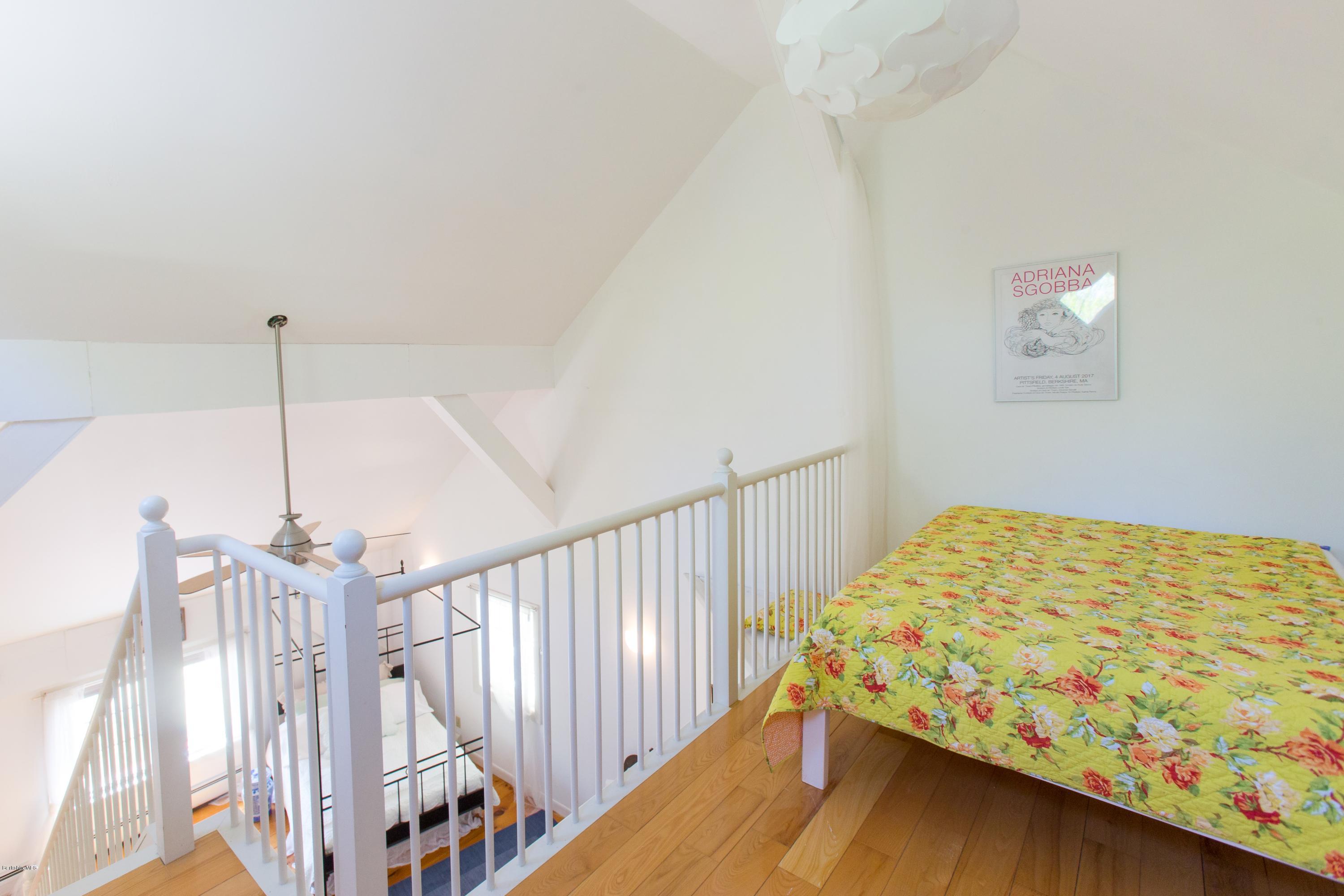 49 New Hartford Road Sandisfield, MA 01255 - Photo 32 of 41 a bed sitting in a bedroom next to a window