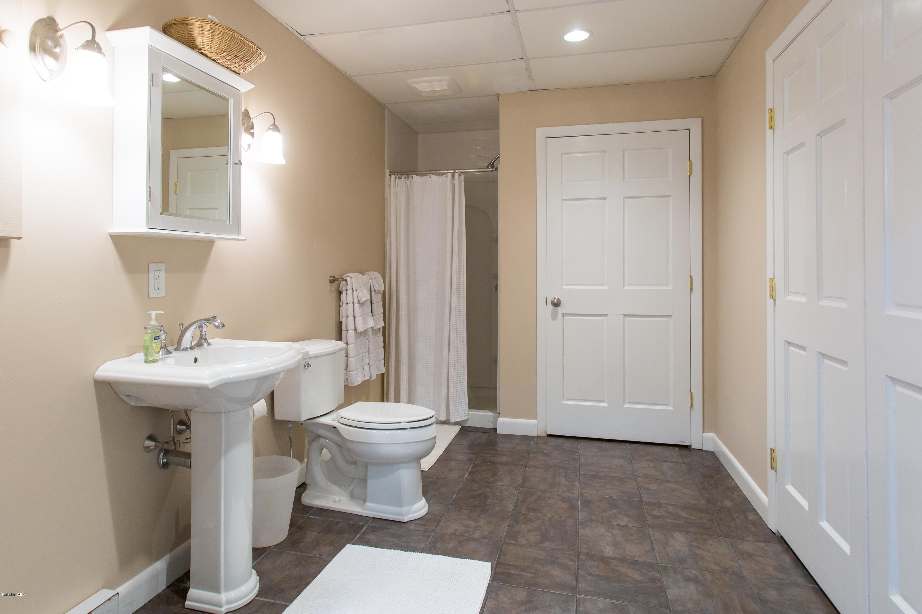 49 New Hartford Road Sandisfield, MA 01255 - Photo 39 of 41 a bathroom with a sink toilet and mirror