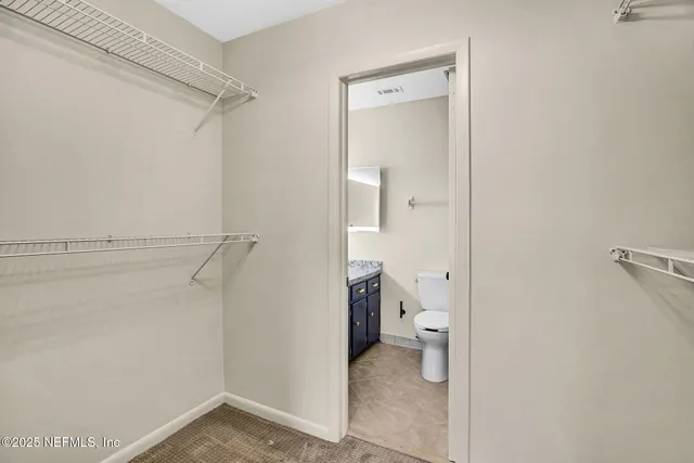 a bathroom with a granite countertop sink toilet and a mirror