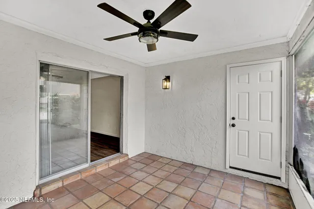 a view of a swimming pool with a patio and trees around