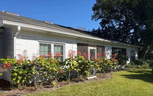 a view of a backyard with sitting area
