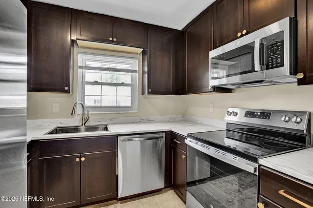 a kitchen with a sink stove and microwave