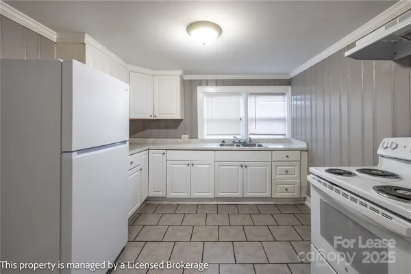 a kitchen with a stove a sink and a refrigerator