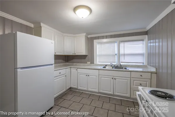 a kitchen with a sink appliances and cabinets