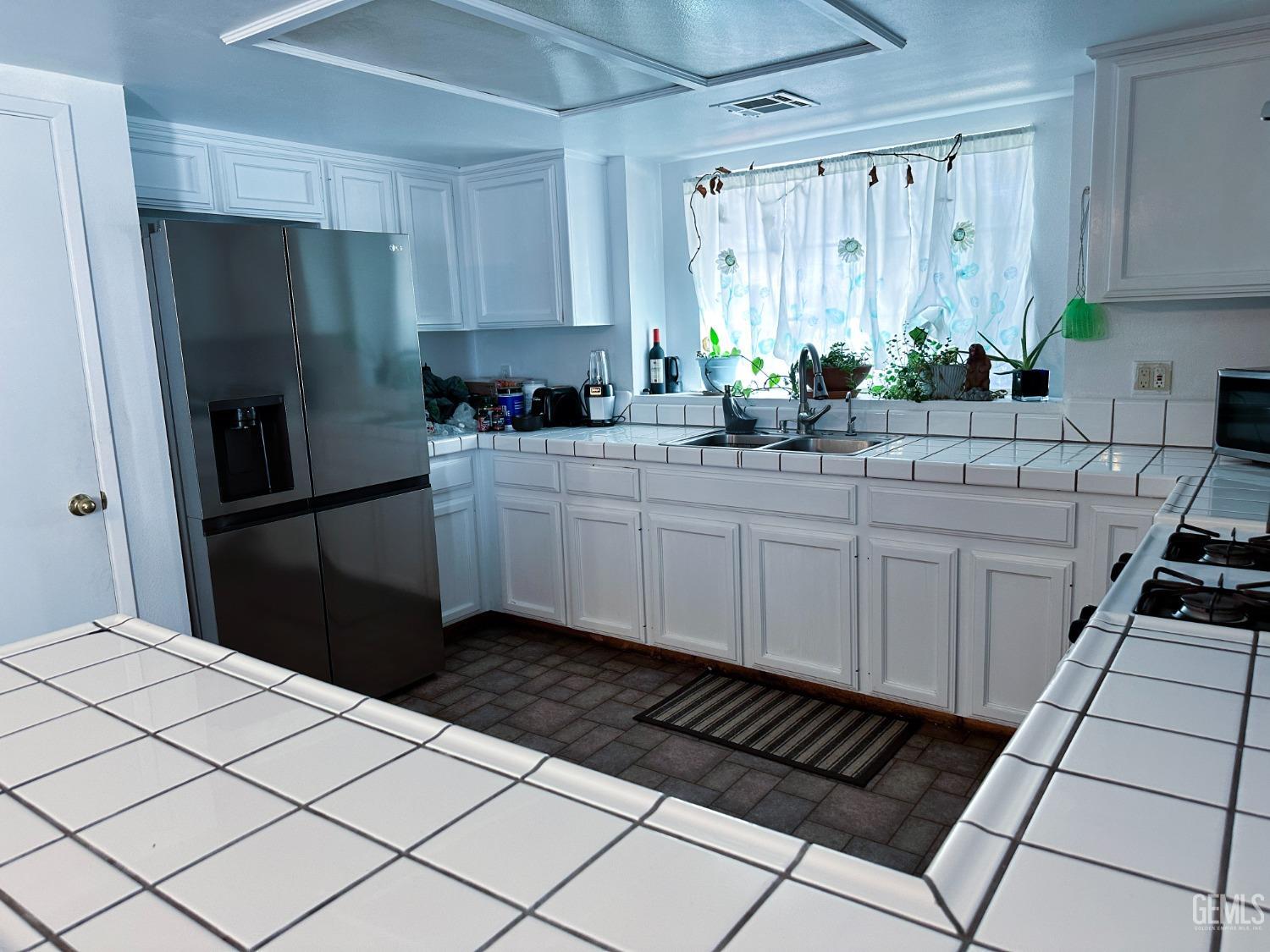 Undisclosed Address Shafter, CA 93263 - Photo 12 of 14 a kitchen with stainless steel appliances a refrigerator sink and cabinets