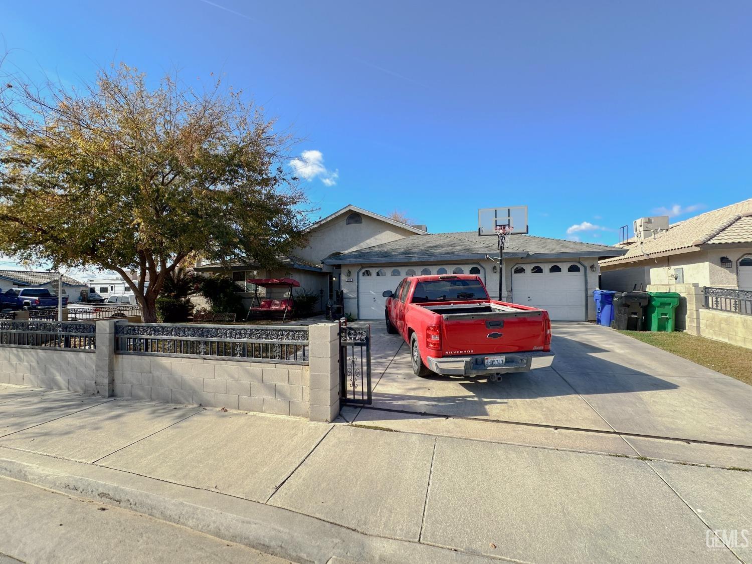 Undisclosed Address Shafter, CA 93263 - Photo 2 of 14 a front view of a house with cars parked