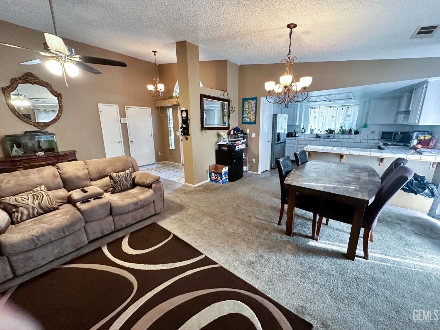 Undisclosed Address Shafter, CA 93263 - Photo 7 of 14 a living room with furniture and a chandelier