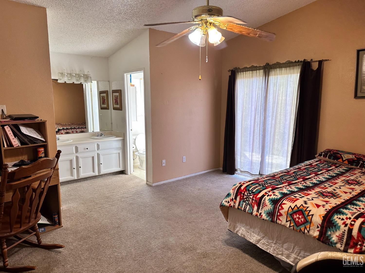 Undisclosed Address Shafter, CA 93263 - Photo 10 of 14 a bedroom with a bed and a chandelier