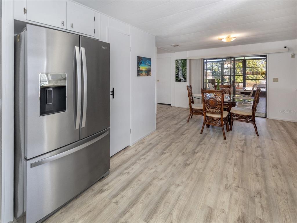 130 Lazy River Road North Port, FL 34287 - Photo 11 of 50 a kitchen with stainless steel appliances a refrigerator a table and chairs