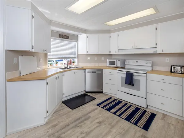 a kitchen with a sink stove and cabinets