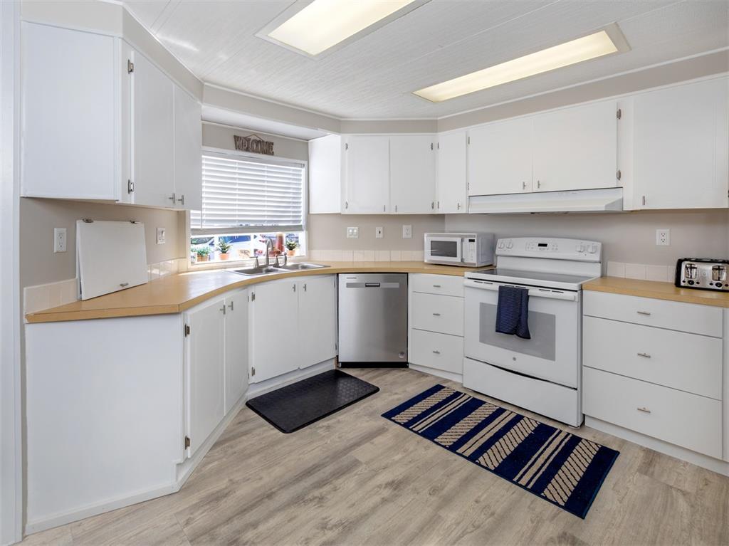 130 Lazy River Road North Port, FL 34287 - Photo 13 of 50 a kitchen with a sink stove and cabinets