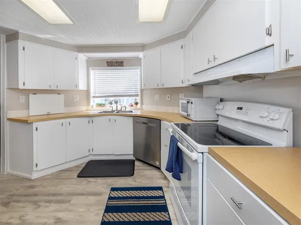 a kitchen with a sink stove and cabinets
