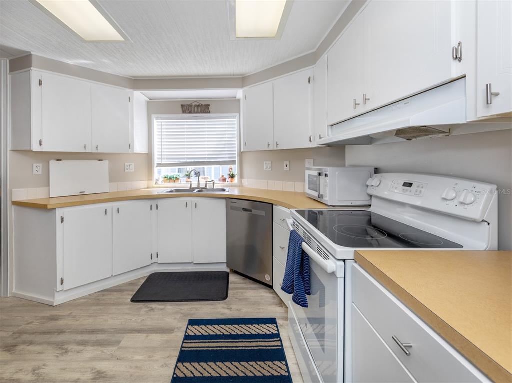 130 Lazy River Road North Port, FL 34287 - Photo 14 of 50 a kitchen with a sink stove and cabinets