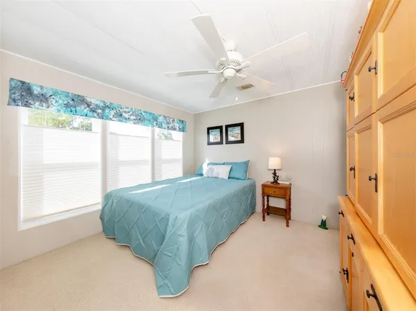 a spacious bedroom with a bed and a window