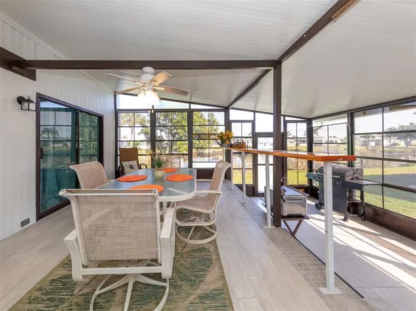 a dining room with furniture water view and large windows