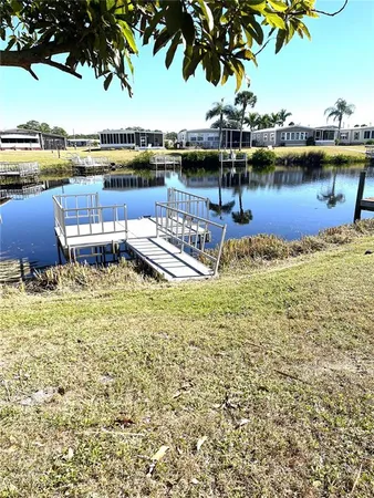 a view of a lake with houses with outdoor seating