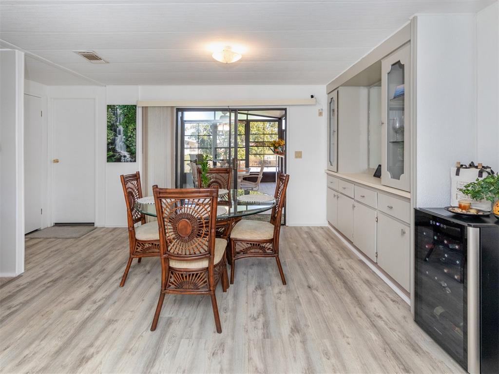 130 Lazy River Road North Port, FL 34287 - Photo 8 of 50 a view of a dining room with furniture and wooden floor