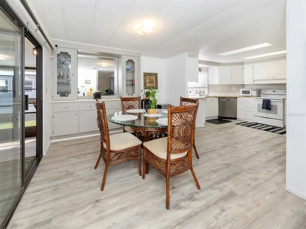 a dining room with kitchen island a table and chairs in it