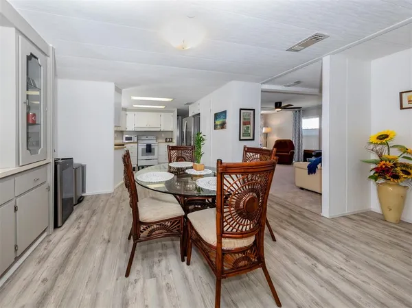 a dining room with a wooden table and chairs