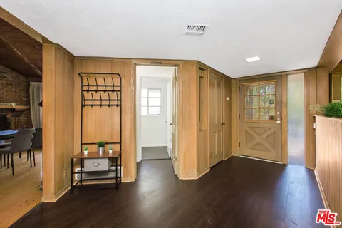 a view of a big room with wooden floor and windows