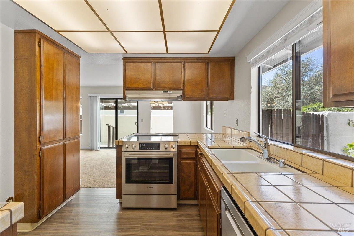 920 Shady Oak Drive Santa Rosa, CA 95404 - Photo 15 of 37 a kitchen with stainless steel appliances granite countertop a sink a stove and a refrigerator
