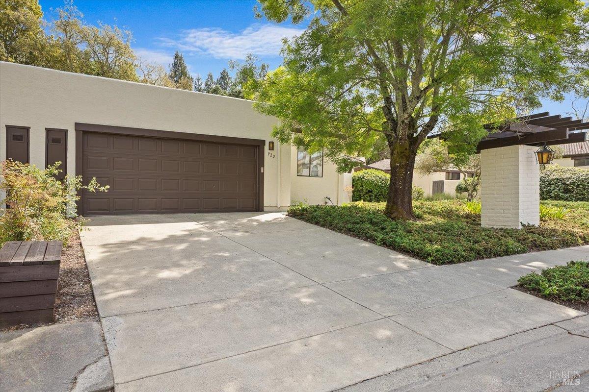 920 Shady Oak Drive Santa Rosa, CA 95404 - Photo 2 of 37 a front view of a house with a yard and a garage